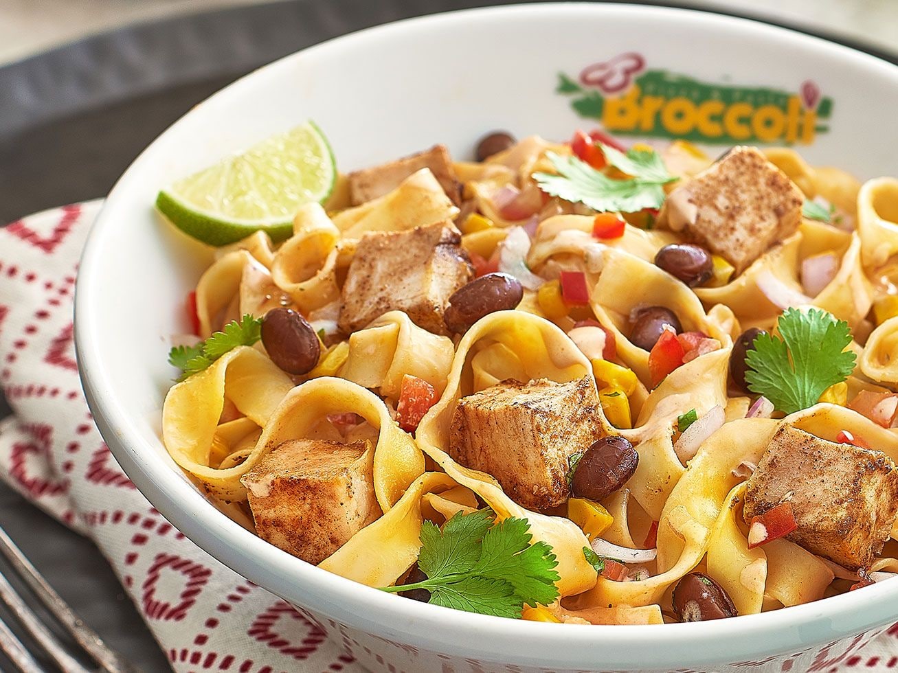 Pasta with vegetables and herbs in a Broccoli-branded bowl